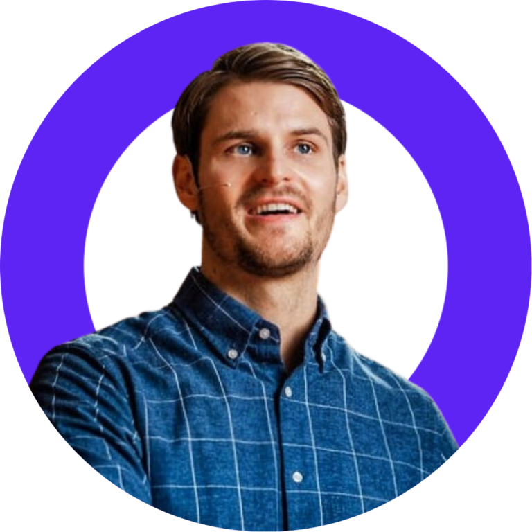 Portrait of a smiling young man in a blue plaid shirt, framed by a purple border.