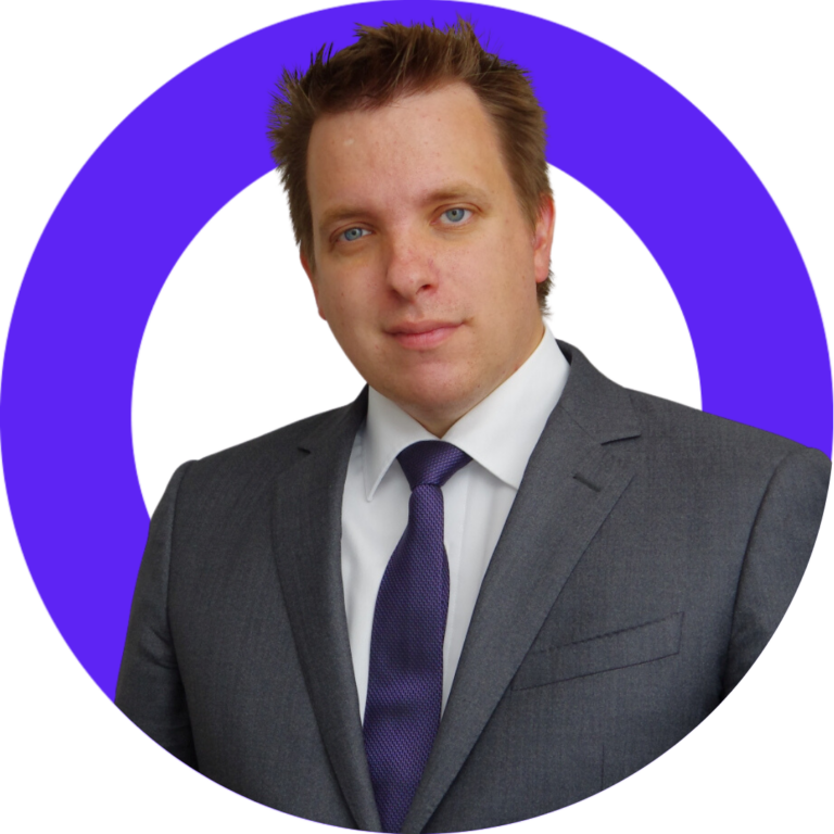 Confident businessman in gray suit and purple tie against a stylized background.