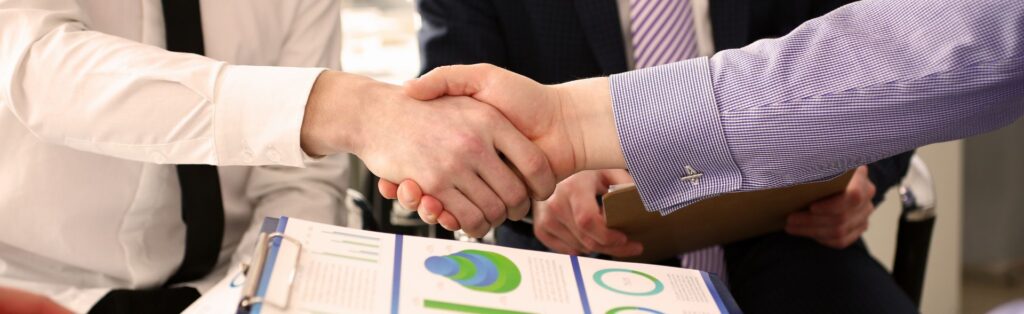 Two colleagues shaking hands. Image accompanying the blog post Qualification Opportunities Act