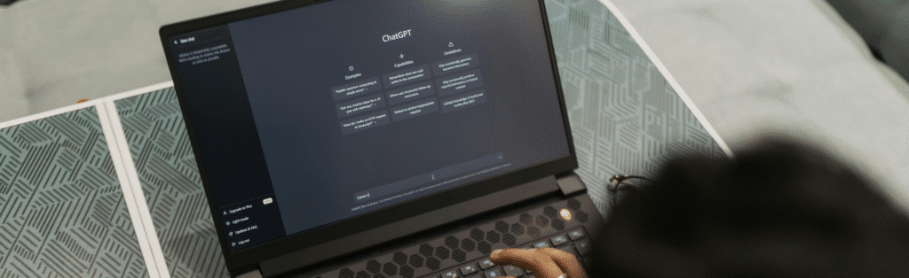 Person uses ChatGPT on a laptop for AI-powered productivity and creative text generation in the office.