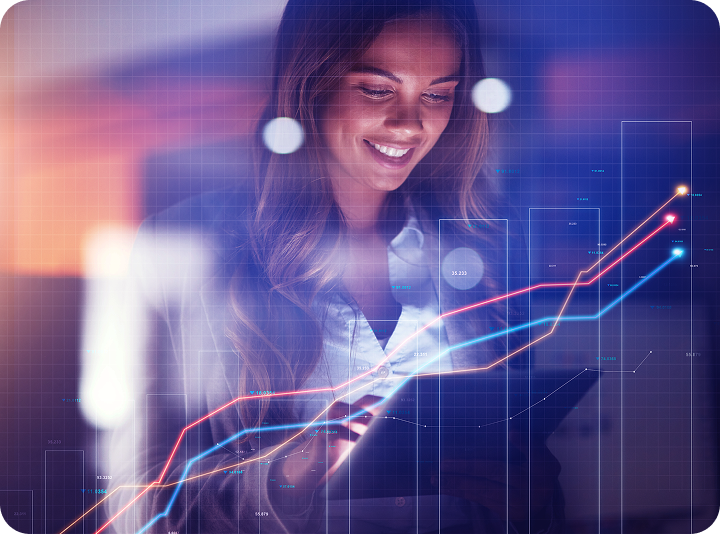 Young data analyst works with futuristic digital financial graphics in modern office.