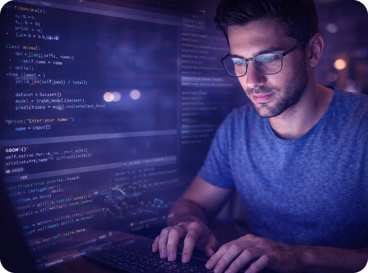 Concentrated programmer codes at night on the computer in a dark, technical working environment.